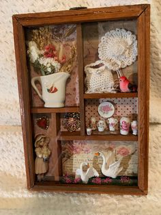 a wooden box filled with figurines and other items