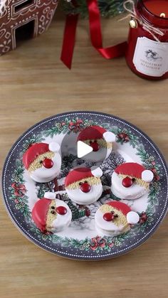 a plate topped with cupcakes covered in frosting next to a christmas tree