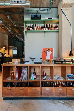 a room with several shelves and bottles on the wall, including an old record player