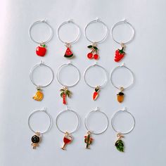 six wine glasses with charms on them sitting next to each other, all in different designs