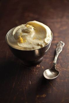 a bowl of pudding and a spoon on a table