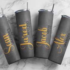 three personalized tumblers sitting on top of a marble counter