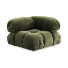 a green chair that is sitting in the middle of a white background and has four pillows on it