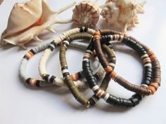 Surfer bracelet, Heshi beads, 5 models. Bracelet for men or women in black and ocher tones. 20 cm approximately, mounted on elastic, diameter 8 mm. You can wear it alone or combined with several. A choice ; - 1, black coconut and vinyl beads - 2, gray vinyl Heishi beads - 3, khaki-colored Heishi beads in vinyl and gold metal - 4 light colored Heishi beads in vinyl and gold metal - 5, brown Heishi beads in vinyl and gold metal Do not hesitate to contact me for a larger or smaller bracelet. Shippi Bracelet Photo, Surfer Bracelets, Women In Black, Small Bracelets, Bracelet For Men, Heishi Beads, Khaki Color, Photo Bracelet, Bracelets For Men