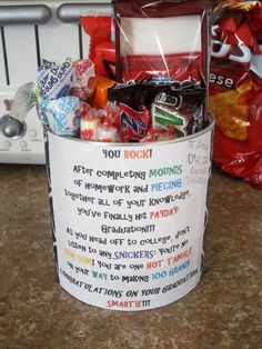 a bucket filled with lots of candy sitting on top of a counter