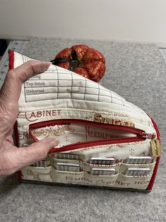 a hand is holding the inside of a purse