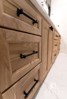 the drawers are made from wood and have black handles