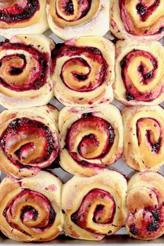 several different types of pastries in a baking pan with cranberry sauce on top