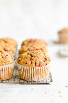 muffins cooling on a wire rack with other muffins in the background