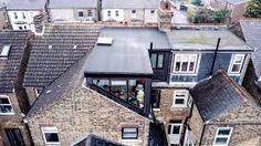 an aerial view of some houses in the middle of a town with lots of windows