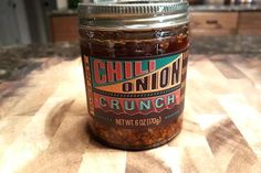 a jar of chili onion crunch sits on a counter