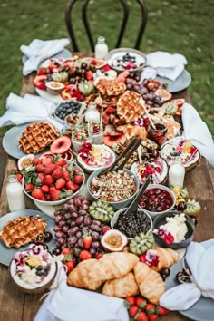 a wooden table topped with lots of food