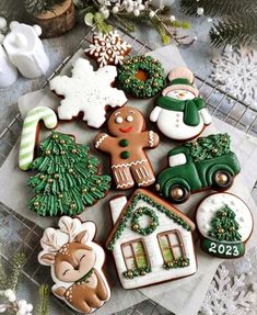 decorated christmas cookies sitting on top of a table