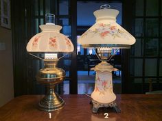 two lamps sitting on top of a wooden table