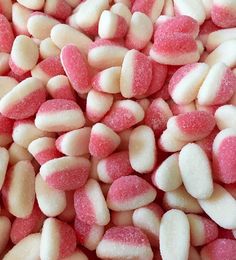 pink and white candy hearts are piled together