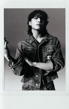 a black and white photo of a person wearing a jean jacket