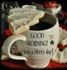 a cup of coffee and some cookies on a red tray with the words good morning have a merry day