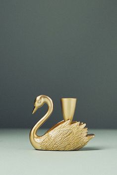 a gold swan figurine sitting on top of a table