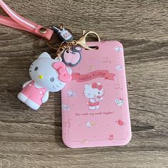 a hello kitty phone case with a keychain attached to it