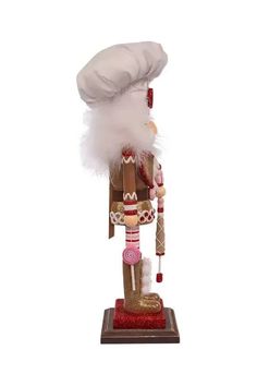 a wooden nutcracker with a white hat on top of it's head