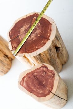 two pieces of wood that have been cut into smaller pieces with a measuring tape on top