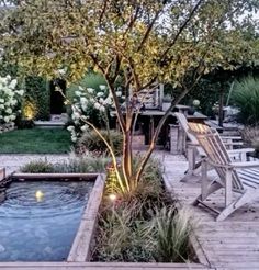 an outdoor garden with a pond and decking area