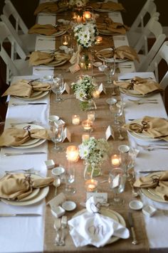 the table is set with white and gold place settings