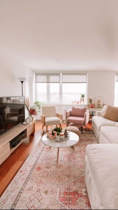 a living room filled with furniture and a flat screen tv