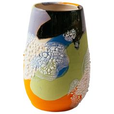 a ceramic vase with an abstract design on the outside and inside, sitting on a white surface