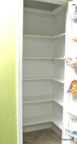 an empty pantry with white shelves filled with food