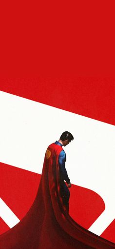 a man in a superman costume standing on top of a red and white sign with the letter d