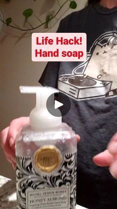 a woman holding a bottle of hand soap in front of her face with the caption life hack hand soap