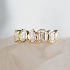 a diamond ring sitting on top of a rock