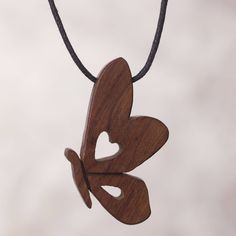 a wooden heart shaped pendant hanging from a cord