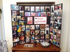 a wooden table topped with pictures and a mirror