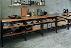 a kitchen with wooden counters and shelves filled with dishes