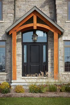 a black front door on a brick house