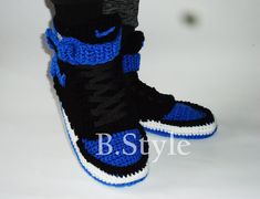 a pair of black and blue sneakers with white soles