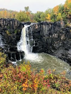 a large waterfall in the middle of a forest