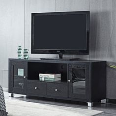 a flat screen tv sitting on top of a black entertainment center