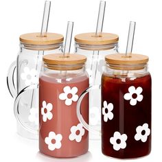 four jars with lids and straws in them