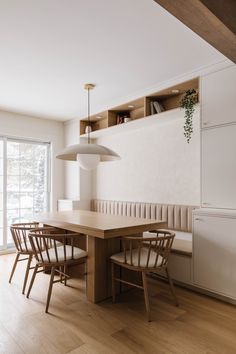 a dining room table with four chairs around it