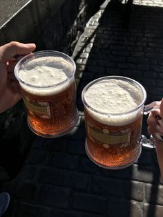 two people toasting with beer in their hands