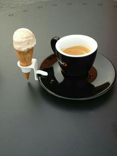 a cup of coffee and an ice cream cone on a saucer