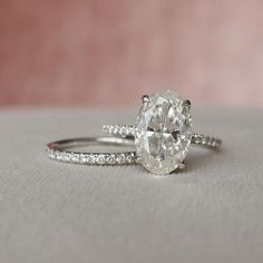 an oval cut diamond ring with pave diamonds on the band