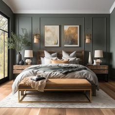 a large bed sitting in a bedroom on top of a hard wood floor next to two lamps