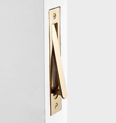 a close up of a door handle on a white door with gold handles and an arrow design