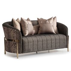 a couch with several pillows on it and a gold frame around the armrests