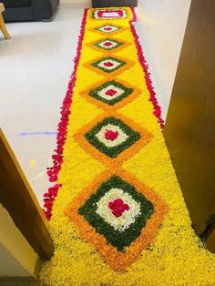 a long yellow and red carpet with flowers on it