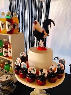 there is a cake with cupcakes on it and a rooster figurine on top